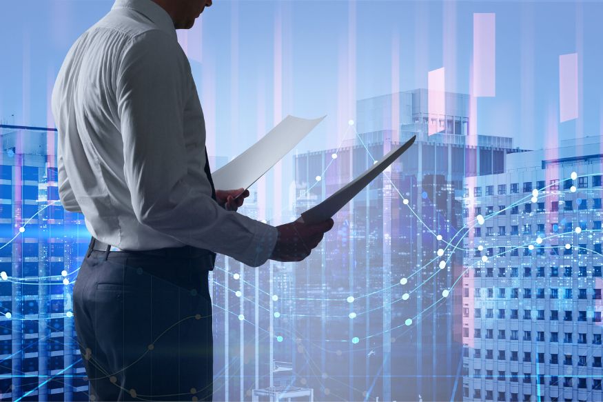 A businessman holding a piece of paper in front of skyscrapers.
