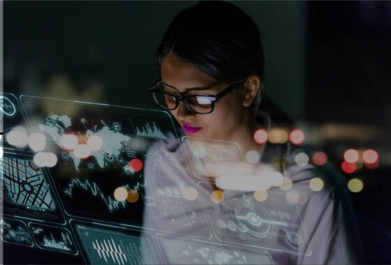 A woman is looking at a collection of different windows and tools computer screen at night.