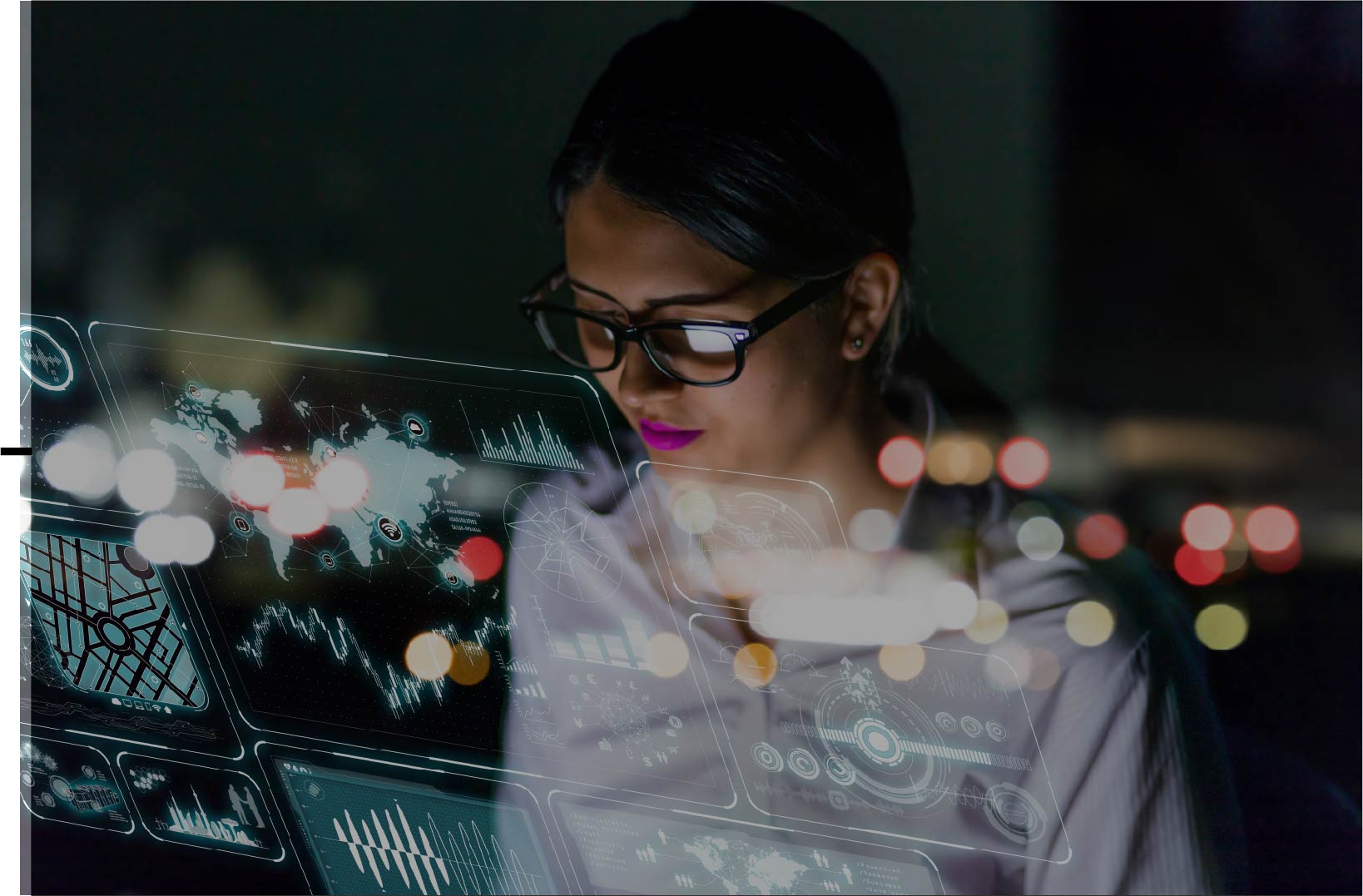 A woman is looking at a collection of different windows and tools computer screen at night.
