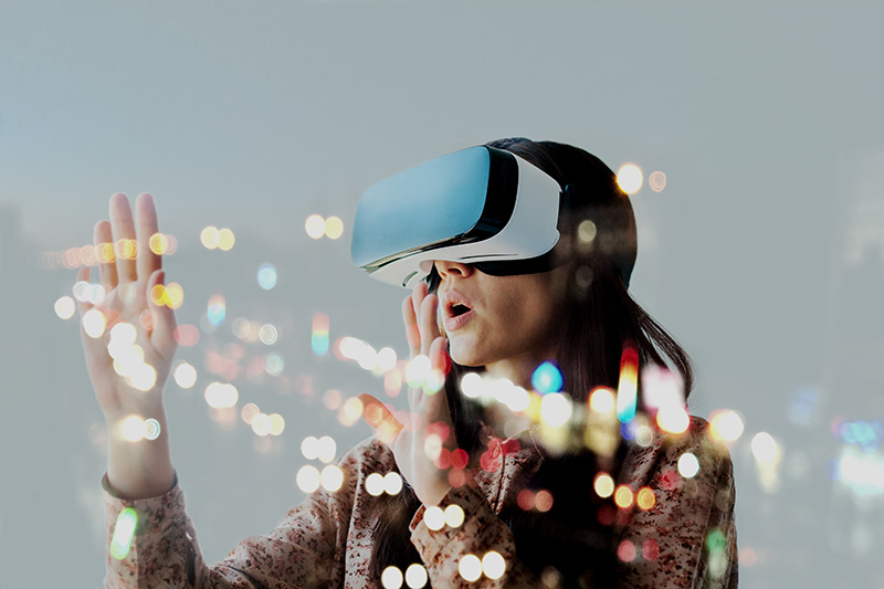 Woman with virtual reality gear and a colourful bokeh on the foreground