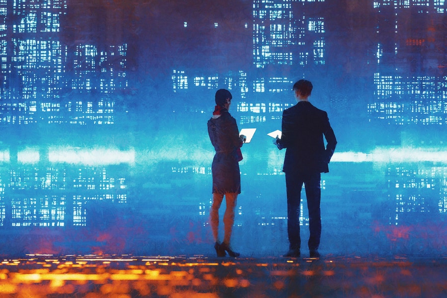 Two business people standing in front of an abstract cityscape background in blue.